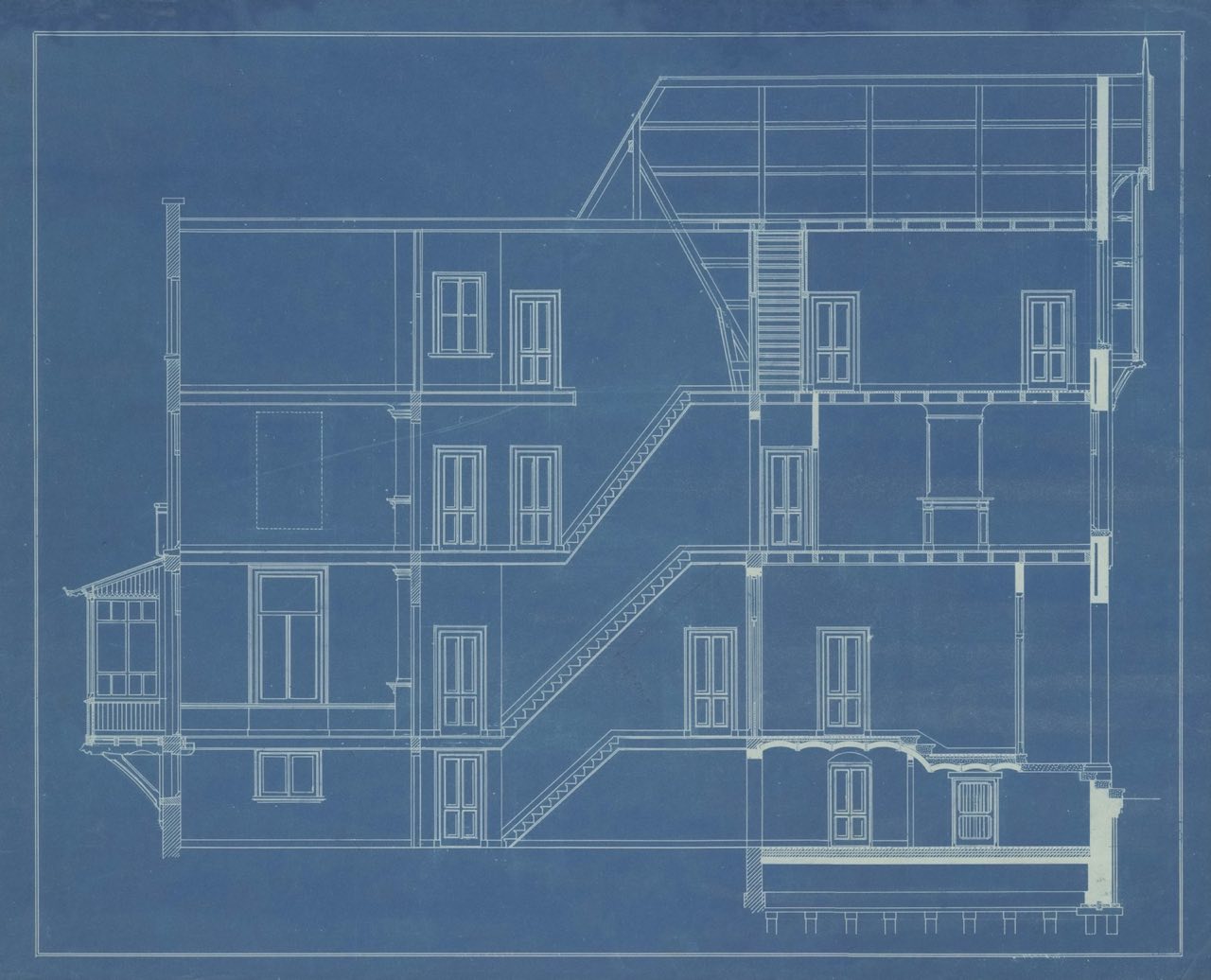 Vintage architectural blueprint showing a multi-story building cross-section in white linework on deep blue